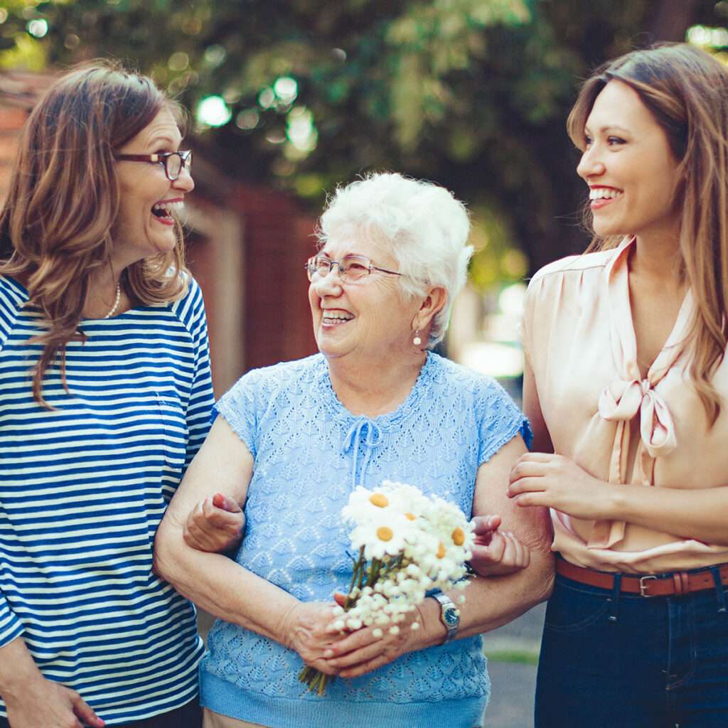 Three women holding arms