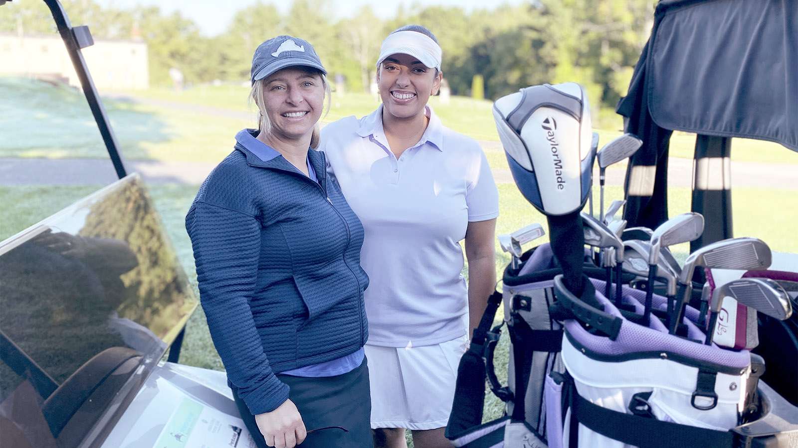 two women golfers smiling