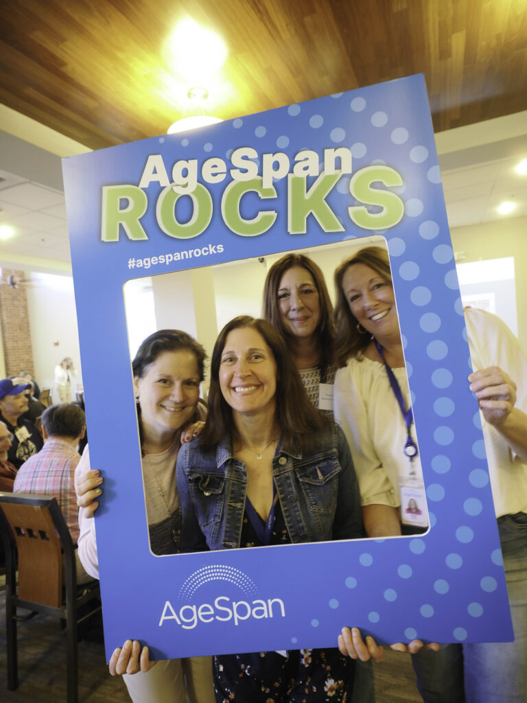 AgeSpan nutrition team poses in AgeSpan rocks frame
