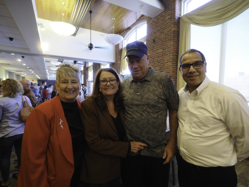 Four people standing together at volunteer event